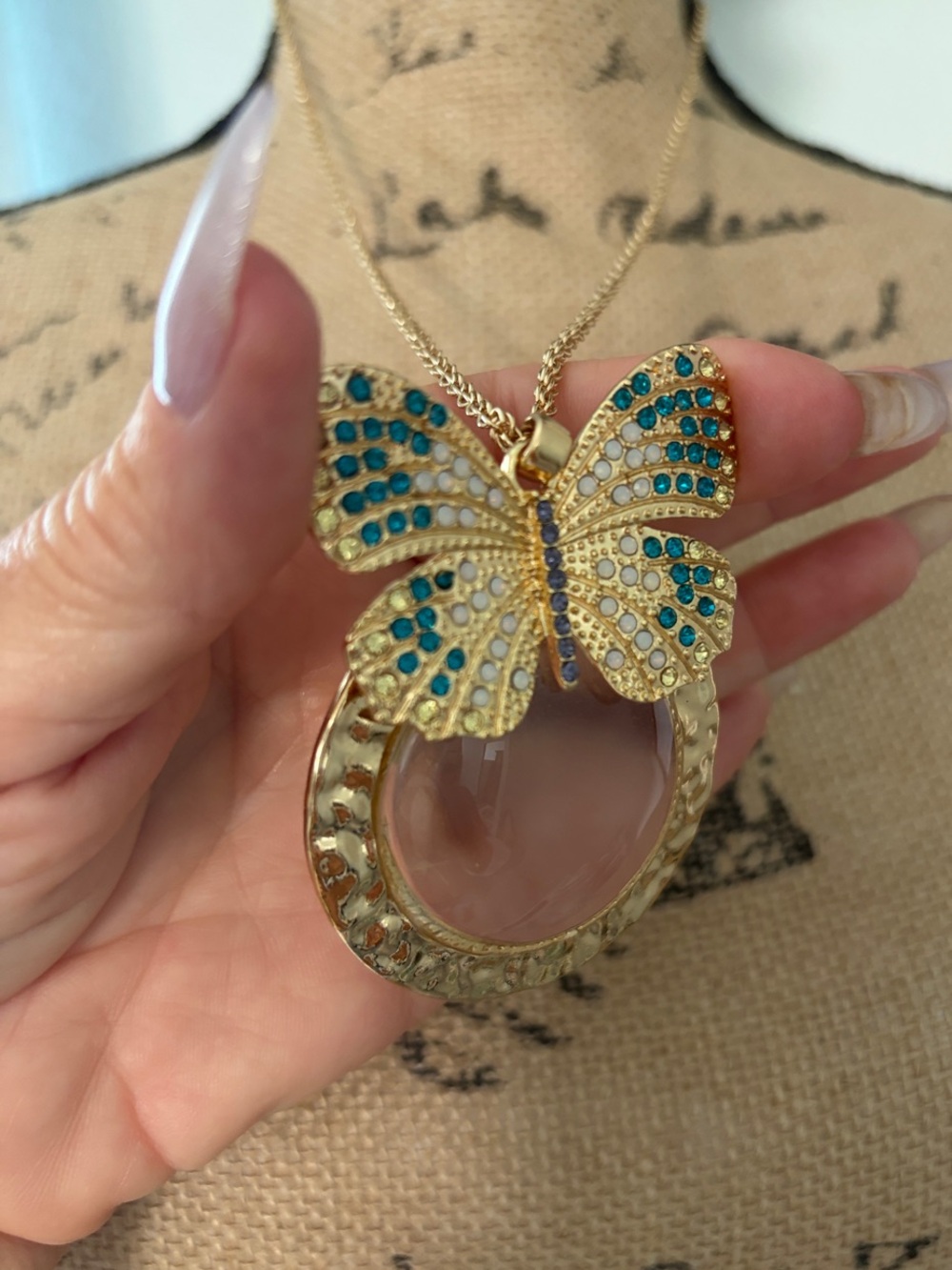 Gold Butterfly Magnifying Glass Necklace with Blue and Teal Accents
